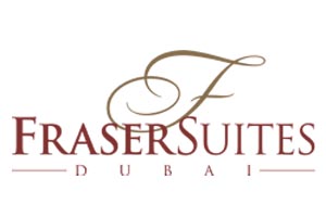 Table with chairs and flowers located near lounge area and kitchen in spacious room of contemporary apartment