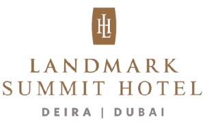 Table with chairs and flowers located near lounge area and kitchen in spacious room of contemporary apartment